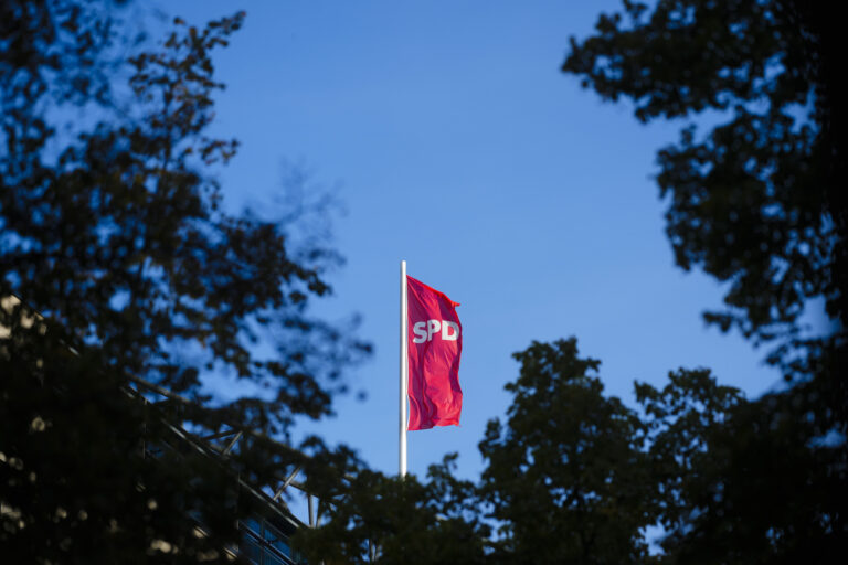 The flag of Olaf Scholz's Social Democratic Party, SPD, waves in the wind on top of the headquarters in Berlin, Germany, Sunday, Sept. 1, 2024. (AP Photo/Markus Schreiber)