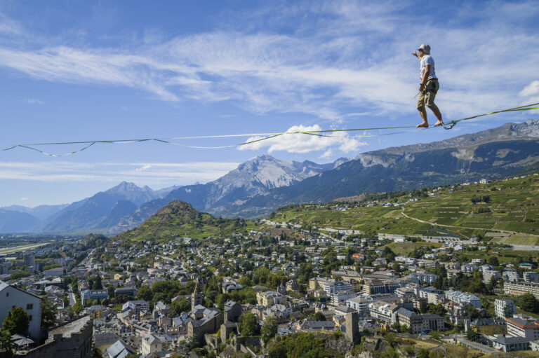 Estonian slackliner Jaan Roose walks on a 300 meter-long slackline between the castles of Valere and Tourbillon during the 