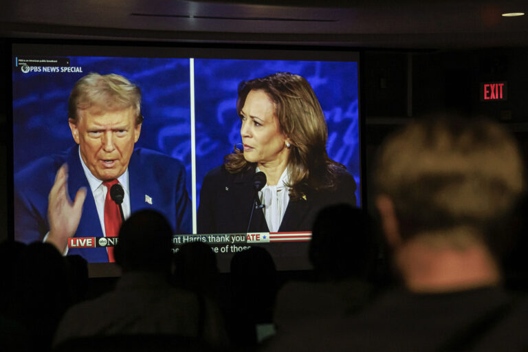 Dr. Christopher Terry's students watch the debate between Republican presidential nominee former President Donald Trump and Democratic presidential nominee Vice President Kamala Harris during a campus watch party at the University of Minnesota's Murphy Hall on Tuesday, Sept. 10, 2024, in Minneapolis. (Kerem Yücel/Minnesota Public Radio via AP)