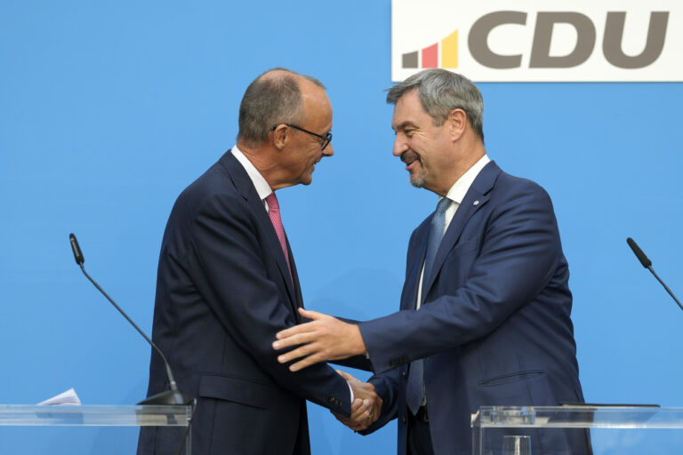 German opposition leader and Christian Democratic Union party chairman Friedrich Merz, left, and Markus Soeder, Christian Social Union party leader and state governor of Bavaria, shake hands at a joint news conference in Berlin, Germany, Tuesday, Sept. 17, 2024. (AP Photo/Markus Schreiber)