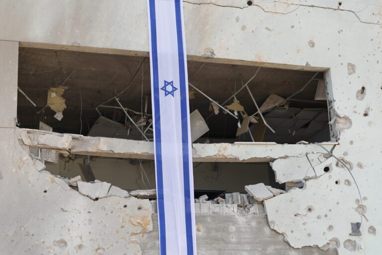 epa11637146 Israeli flags hang from a school damaged by ballistic missiles fired from Iran, in Gedera, Israel, 02 October 2024. According to the Israeli military, Iran launched over 180 ballistic missiles towards Israel in the evening of 01 October, with alert sirens sounding across the country. EPA/ABIR SULTAN