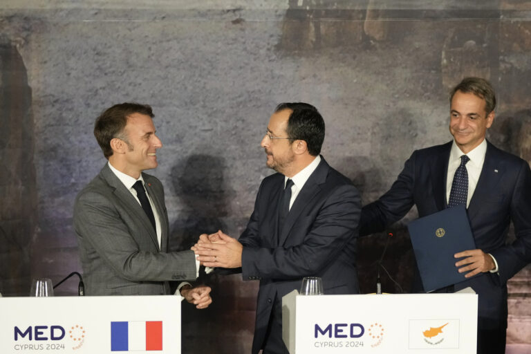 French President Emmanuel Macron, left, shakes hands with Cyprus' President Nikos Christodoulides, as Greece's Prime Minister Kyriakos Mitsitakis approach them after the end of a press conference in Paphos ,Cyprus, on Friday, Oct 11, 2024 as the leaders of nine southern European Union member countries and Jordan are meeting to come up with ways of de-escalating the conflict in the Middle East (AP Photo/Petros Karadjias)