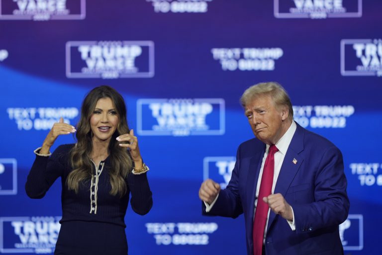 Republican presidential nominee former President Donald Trump and South Dakota Gov. Kristi Noem dance to the song 