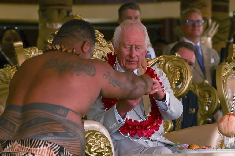 Britain's King Charles III receives a drink during the bestowing and farewell ceremony on the final day of the royal visit to Samoa at the Siumu Village in Apia, Samoa, Saturday, Oct. 26, 2024. (Manaui Faulalo/Pool Photo via AP)