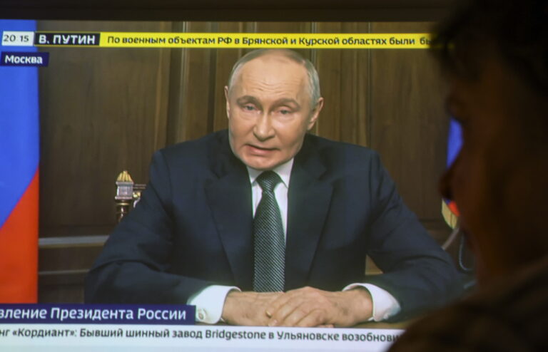 epa11733442 A person watches a televised address by Russian President Vladimir Putin, in Moscow, Russia, 21 November 2024. Putin announced a successful test of the latest medium-range missile 