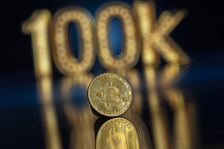 A symbolic Bitcoin in front of a 100k Sign, in Lugano, Switzerland, Friday, November 22, 2024. The most important crypto currency hit a record high on Thursday and is approaching the 100'000 dollars per coin mark. Bitcoin has been regularly hitting fresh records this month on hopes that Trump will usher in a golden age of crypto.(KEYSTONE/Ti-Press/Pablo Gianinazzi)