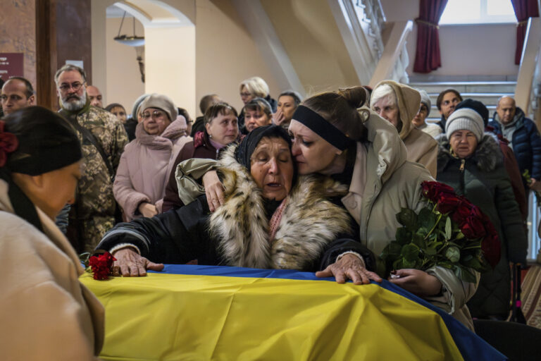 Relatives and colleagues say the last goodbye to a soldier, leading actor Petro Velykiy, 48, who was killed in a battle with the Russian troops in Russia's Kursk region, during farewell ceremony in the music and drama theatre in Chernyhiv, Ukraine, Wednesday, Nov. 27, 2024. (AP Photo/Dan Bashakov)