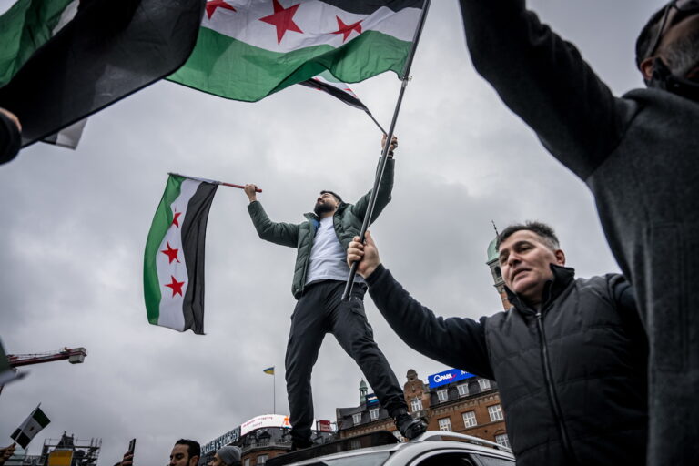 epa11764978 People and members of the Syrian Association in Denmark carry Syrian opposition flags as they celebrate the rebel takeover of Damascus, in Copenhagen, Denmark, 08 December 2024. Syrian rebels entered Damascus on 08 December 2024 and announced in a televised statement the 'Liberation of the city of Damascus and the overthrow of Bashar al-Assad', as well as the release of all the prisoners. The rebels also urged the Syrian armed forces to leave Syrian public institutions, which will stay under the control of the outgoing Syrian prime minister until the official handover ceremony. EPA/EMIL HELMS DENMARK OUT