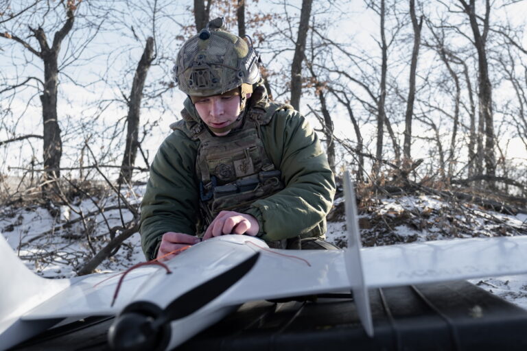 epa11777719 Ukrainian serviceman of the 12th Special Operations Brigade 'Azov', drone pilot 'Scout' inspects a Ukrainian 'Furia' unmanned aerial system (UAS) prior to conduct an aerial reconnaissance mission at an undisclosed location near the frontline city of Toretsk, Donetsk region, eastern Ukraine, 14 December 2024, amid the Russian invasion. EPA/MARIA SENOVILLA