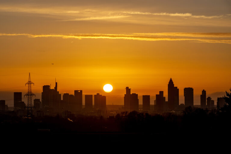 The sun rises over the buildings of the banking district in Frankfurt, Germany, Tuesday, Dec. 24, 2024. (AP Photo/Michael Probst)