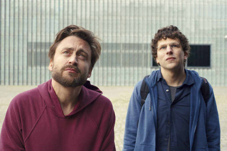 This image released by Searchlight Pictures shows Kieran Culkin, left, and Jesse Eisenberg in a scene from 