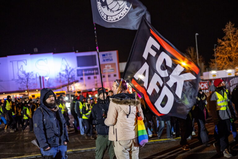 epa11817913 Demonstrators march in front of the conference hall ahead of an Alternative for Germany (AfD) federal conference, in Riesa, Germany, 11 January 2025. The AfD will hold the 16th Federal Party Congress on 11 and 12 January to elect the partyâÄ™s candidate for chancellor and to adopt its federal election program, ahead of the early general elections scheduled on 23 February. EPA/MARTIN DIVISEK