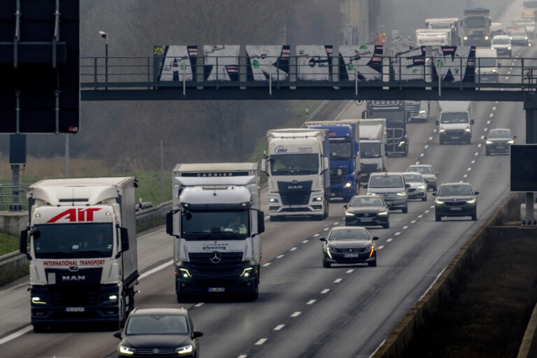 Trucks and cars move along on a highway in Frankfurt, Germany, Wednesday, Jan. 15, 2025. (AP Photo/Michael Probst)