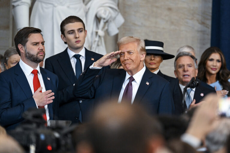 President Donald Trump salutes as Melania Trump, from background third right, Barron Trump and Vice President JD Vance watch during the 60th Presidential Inauguration in the Rotunda of the U.S. Capitol in Washington, Monday, Jan. 20, 2025. (Kenny Holston/The New York Times via AP, Pool)