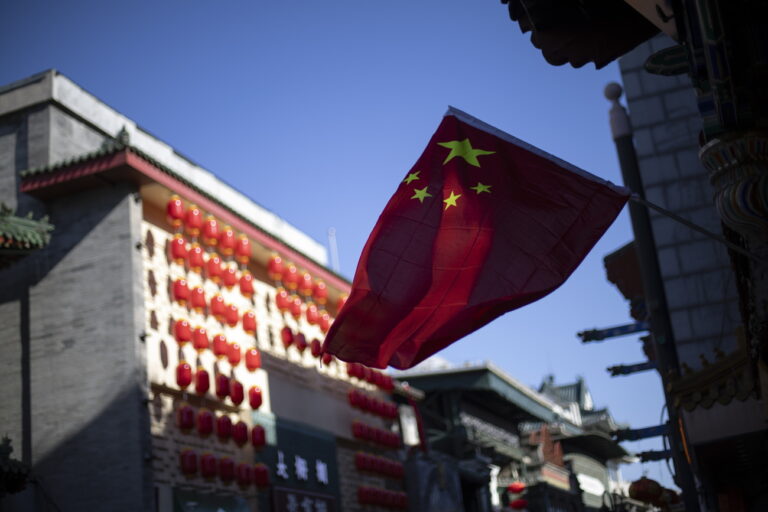 epa11856084 A Chinese flag waves next to lanterns on a street in Beijing, China, 27 January 2025, ahead of the Lunar New Year. The Chinese Lunar New Year, also called the Spring Festival, falls on 29 January 2025, marking the beginning of the Year of the Snake. EPA/ANDRES MARTINEZ CASARES