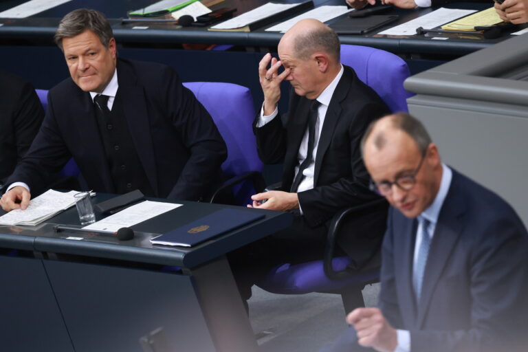 epa11860499 German Chancellor Olaf Scholz (C) and German Minister for Economy and Climate Robert Habeck (L) look on as Chairman of the Christian Democratic Union (CDU) party and faction Friedrich Merz (R) speaks during a session of the German parliament 'Bundestag' in Berlin, Germany, 29 January 2025. One of the main topics of session of the Bundestag is the delivery of a government statement by German Chancellor Olaf Scholz on current domestic policy issues. EPA/CLEMENS BILAN