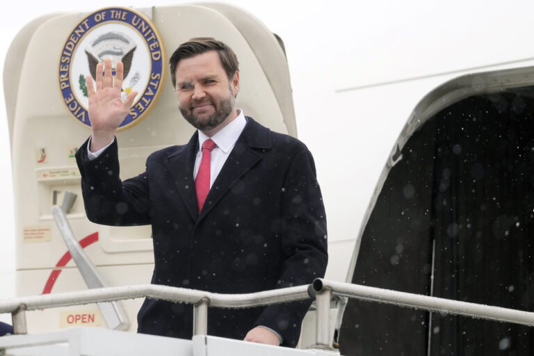 U.S. Vice President JD Vance waves as he arrives at the Munich airport, in Munich, Germany, Thursday, Feb. 13, 2025. (AP Photo/Matthias Schrader)