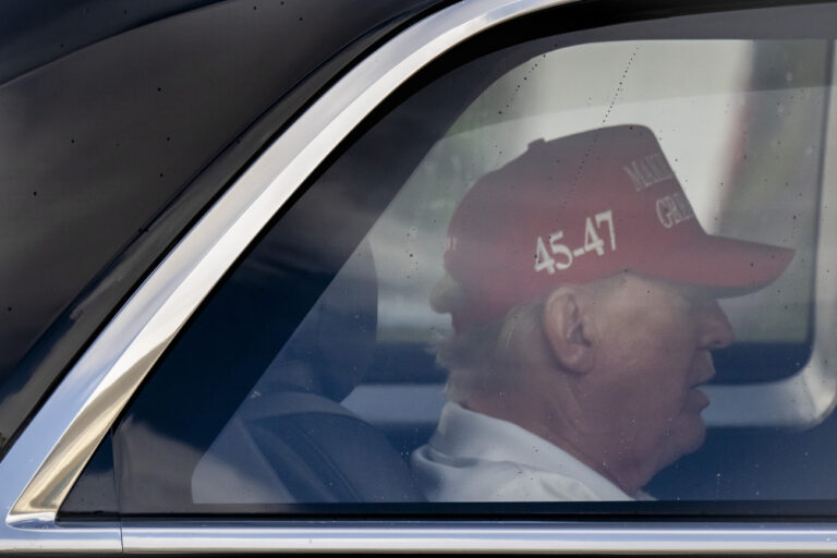 President Donald Trump is seen in his motorcade driving through West Palm Beach, Fla., Wednesday, Feb. 19, 2025, en route to Palm Beach International Airport. (AP Photo/Ben Curtis)