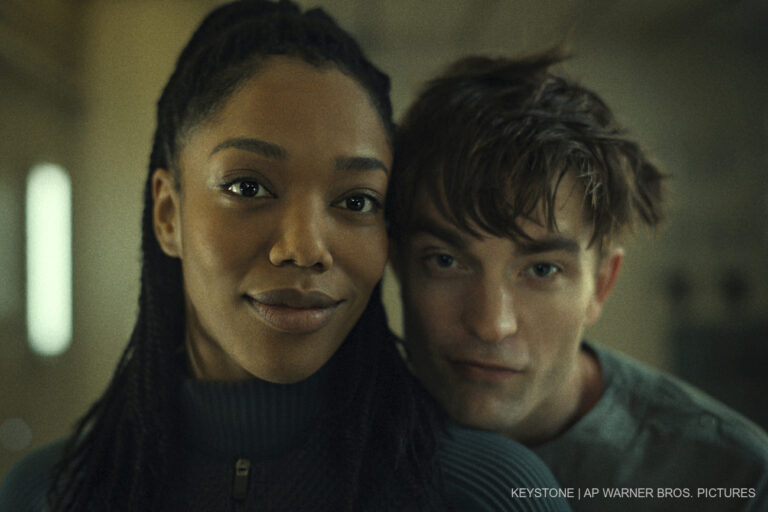 This image released by Warner Bros. Pictures shows Naomi Ackie, left, and Robert Pattinson in a scene from 