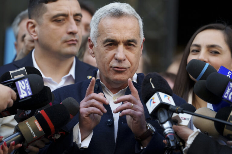 Calin Georgescu, the winner of the first round of presidential elections, later annulled by the Constitutional Court, speaks to media after registering his new bid for the country's presidency outside Romania's Electoral Authority, in Bucharest, Romania, Friday, March 7, 2025. (AP Photo/Andreea Alexandru)