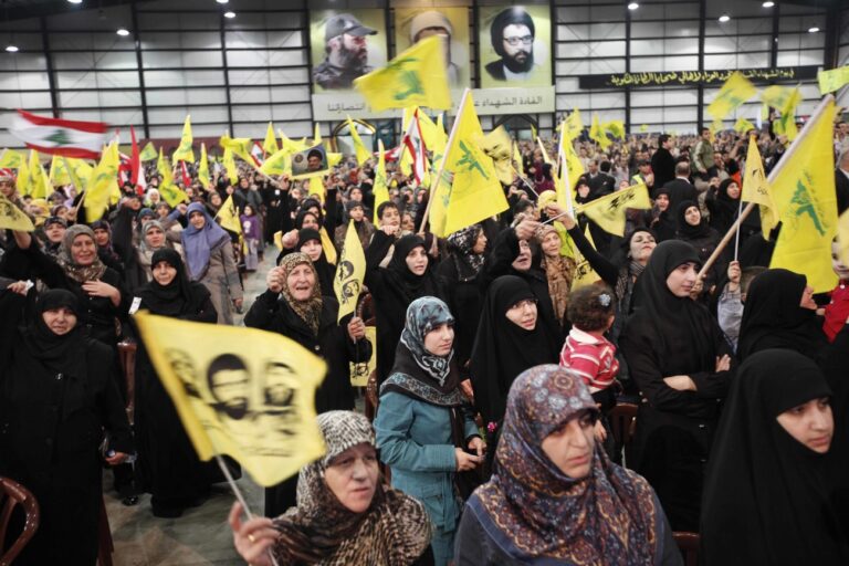 Hezbollah supporters listen to the speech of Hezbollah leader Hassan Nasrallah during a rally commemorating the 2008 assassination of Hezbollah's top military commander Imad Mughniyeh, in Beirut's southern suburbs, Lebanon, Tuesday, Feb. 16, 2010. Nasrallah spoke Tuesday through a giant screen from a secret location saying if Israel attacks Lebanon's infrastructure in the future they will retaliate by bombing Tel Aviv's Ben Gurion airport as well as other facilities in the Jewish state. (AP Photo/Bilal Hussein)