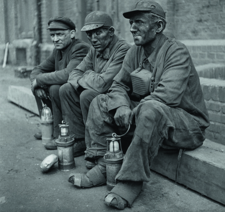 6th August 1947:  Three coal miners in the Ruhr with their lamps and canteen boxes take a break.  (Photo by Fred Ramage/Keystone Features/Getty Images)